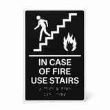 ADA Compliant Elevator Sign – "In Case of Fire Use Stairs," Tactile with Braille — Black studio product view; SKU ICOF69K.